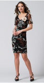 Woman wearing fitted dress with sheer short sleeves and removable flower brooch, posing confidently
