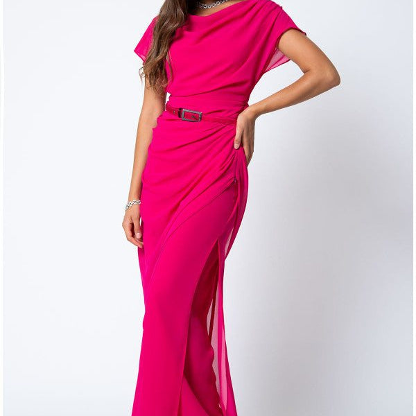 Woman wearing bright hot pink Overall Tina with belted waist and draped layered design posing on white background