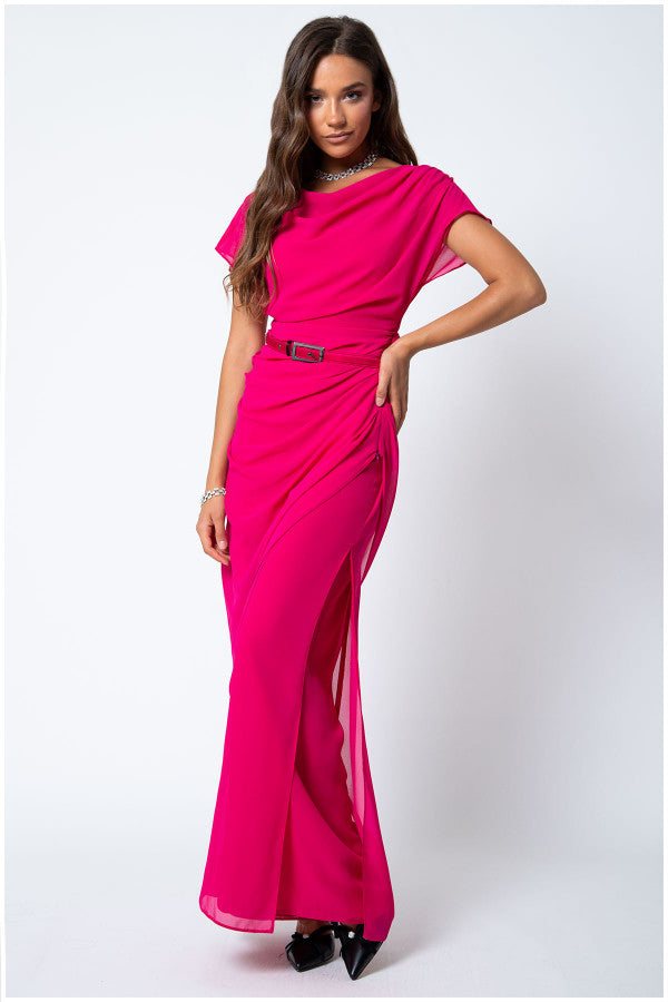 Woman wearing bright hot pink Overall Tina with belted waist and draped layered design posing on white background