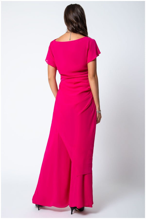 Woman wearing a solid hot pink Overall Tina with a belted waist and layered design, shown from the back on white background