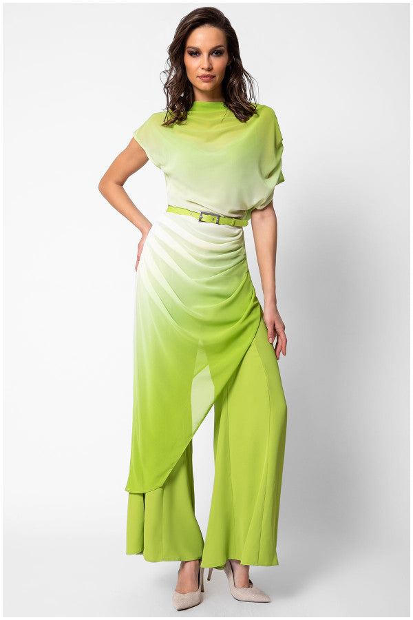 Woman wearing the green overall Tina with belted waist and flared legs in a modern elegant style