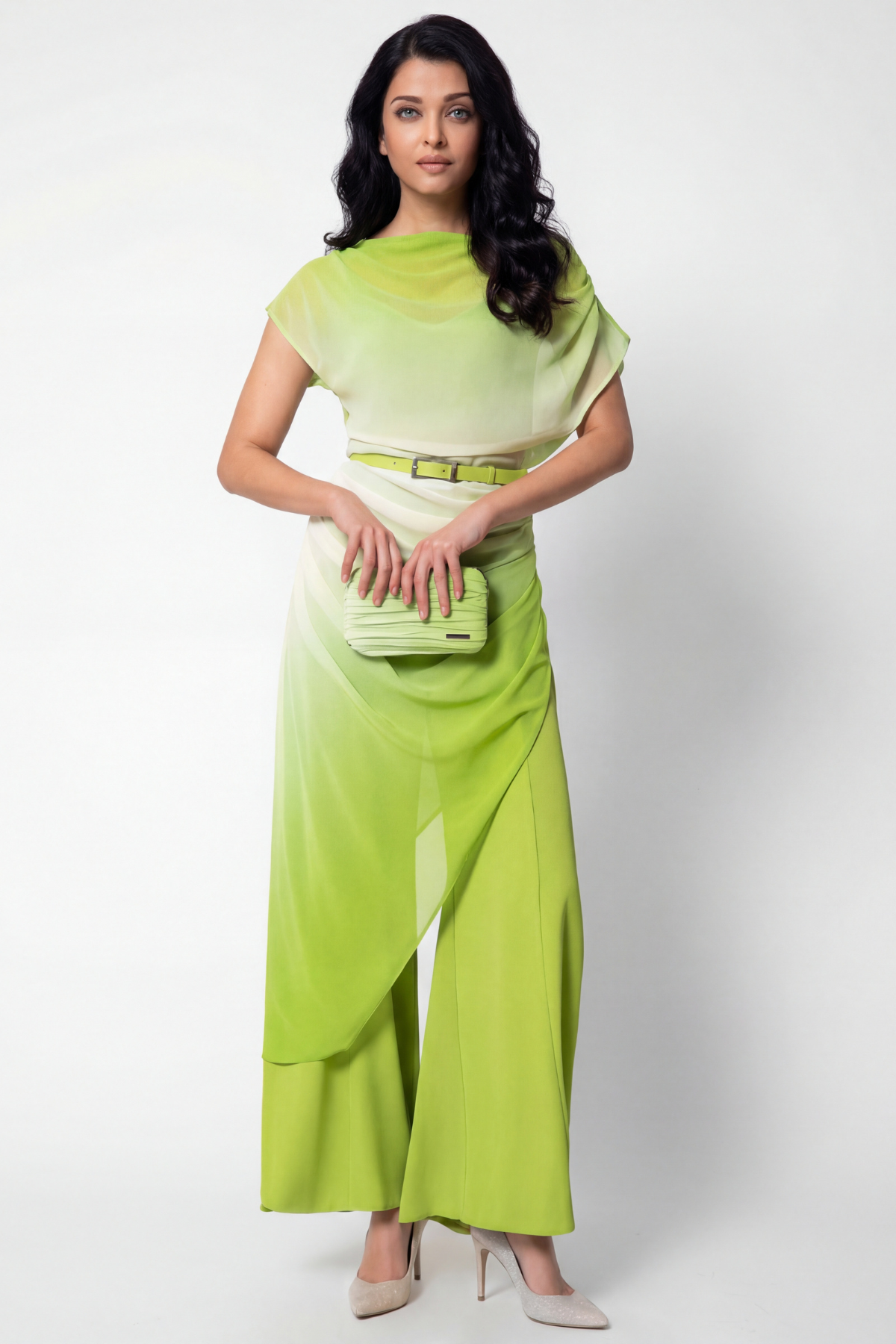 Woman wearing a green outfit with a belt on a white background
