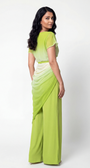 Woman wearing a green and white ombre saree on a white background