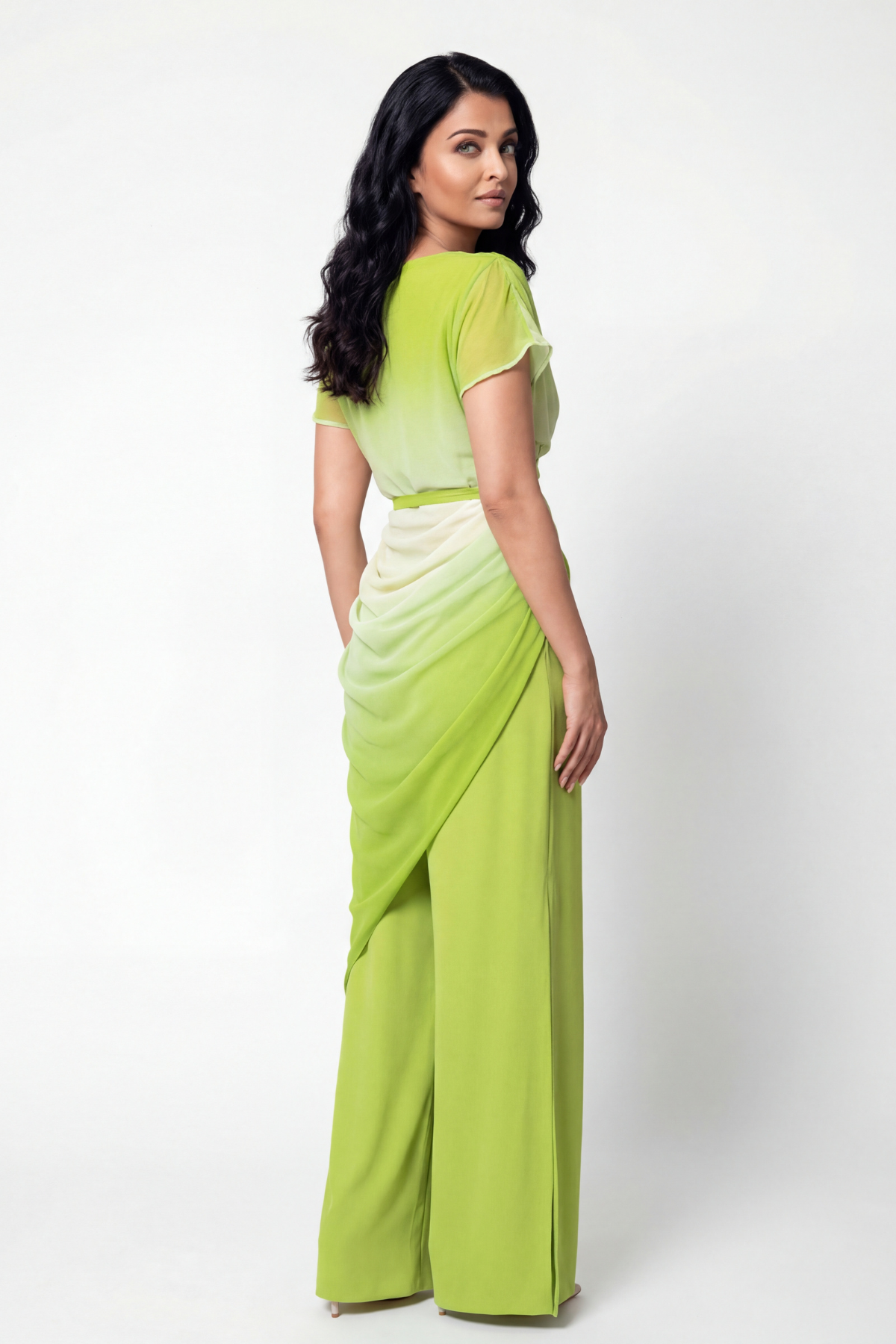 Woman wearing a green and white ombre saree on a white background