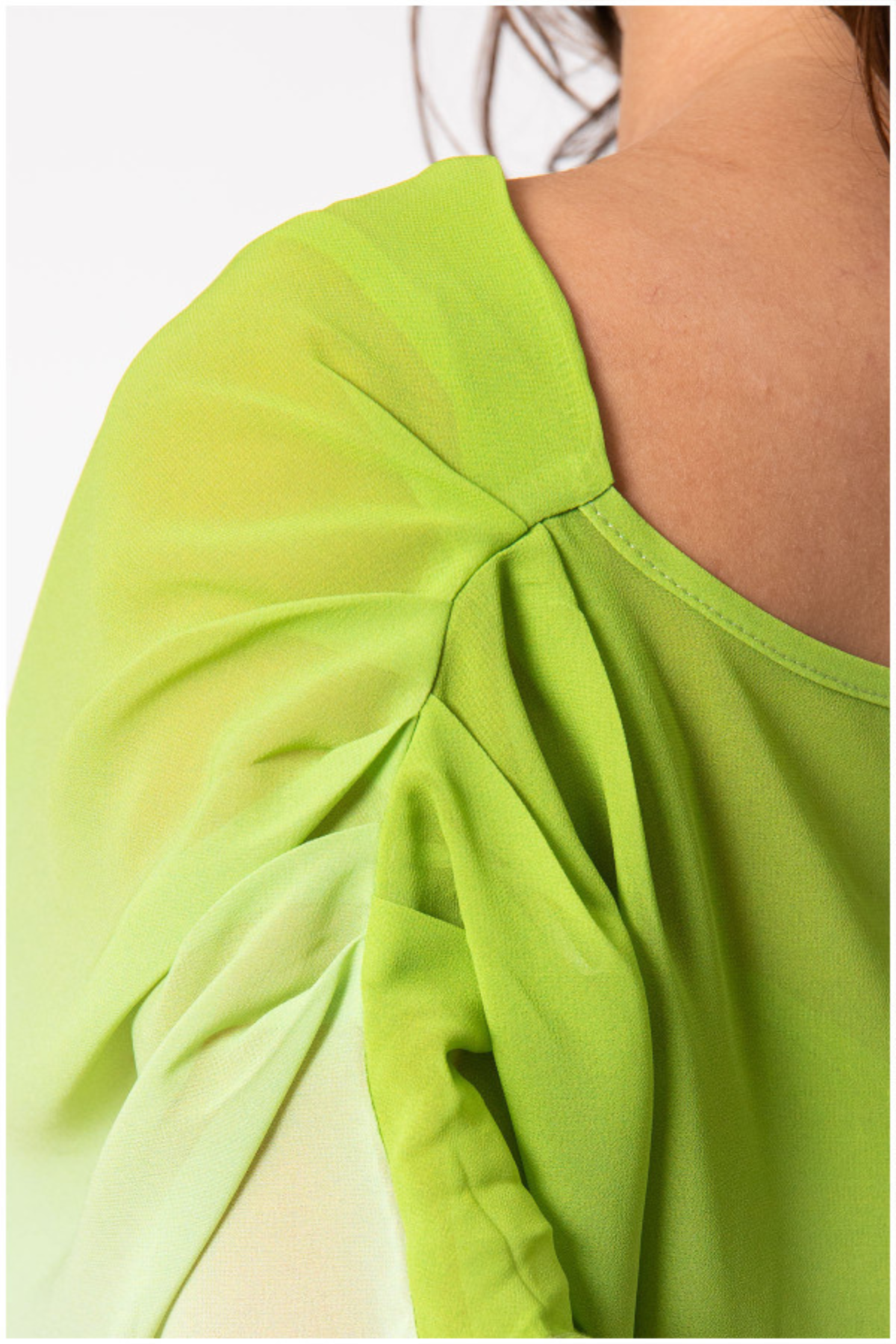 Green fabric with a draped design on a plain background
