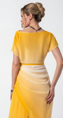 Woman wearing a yellow dress with a plain background