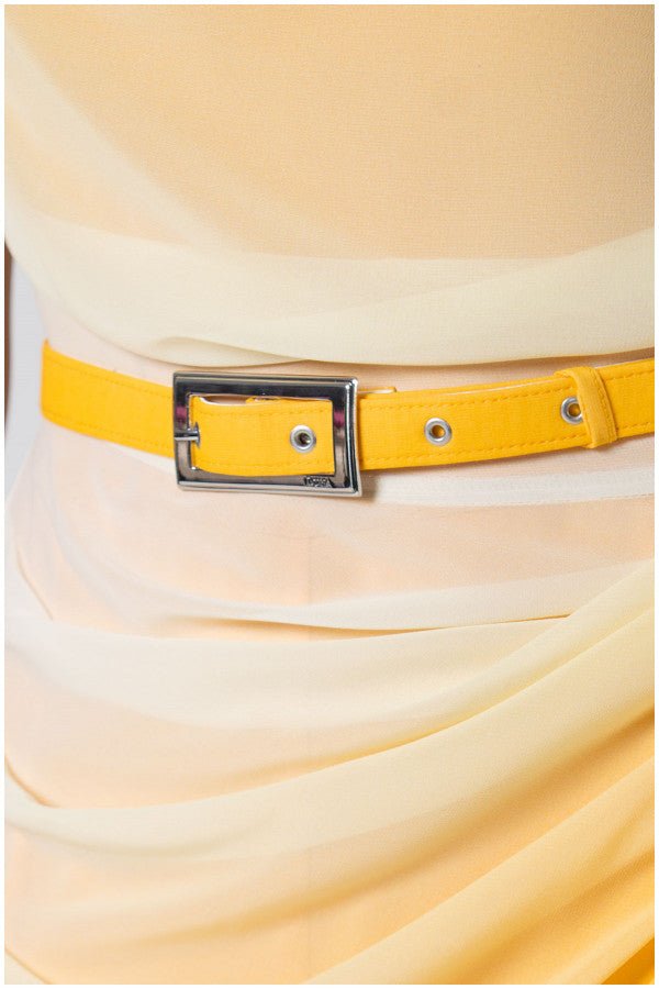 Close-up Yellow Overall detail of luminous yellow ombre belt with silver buckle accentuating waist on flowing fabric overall dress.