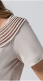 Beige short-sleeve top with a subtle pattern on a plain background