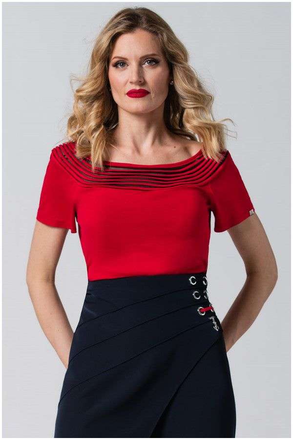 Woman in red office elegant blouse Lola Top with pleated neckline and short sleeves paired with a navy skirt.