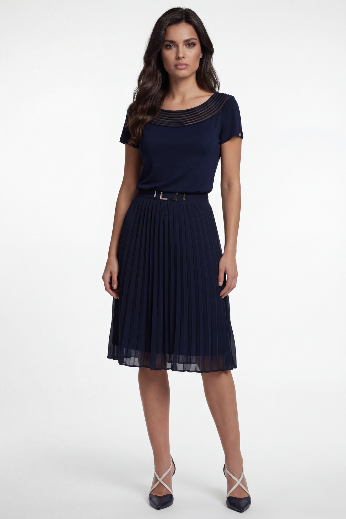 Woman wearing a navy dress with a belt on a white background