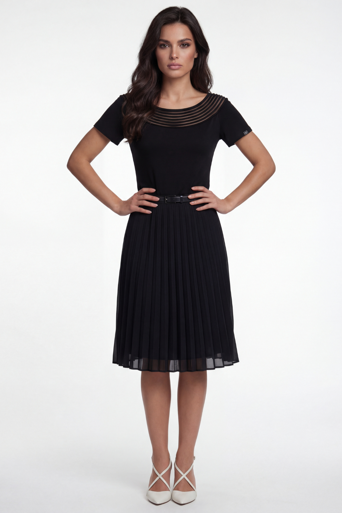 Woman wearing a black dress with a textured neckline on a white background