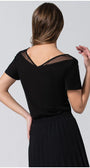 Back view of woman wearing black Lola business Top with pleated neckline and short sleeves paired with a black skirt