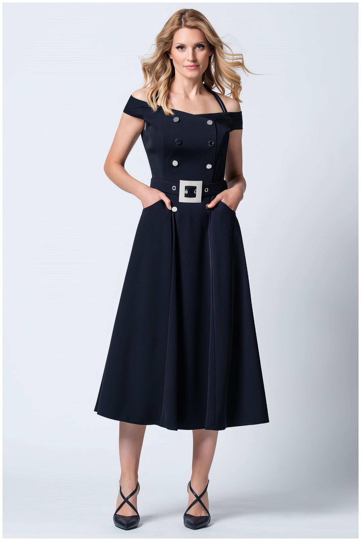 Greta Off-Shoulder Dress in Navy. Off-shoulder dress. Navy midi dress with silver buttons, a belt with a square silver buckle, and side pockets.