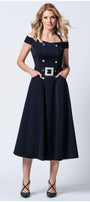 Woman wearing navy off-shoulder elegant midi dress with buttons and pockets against a white background