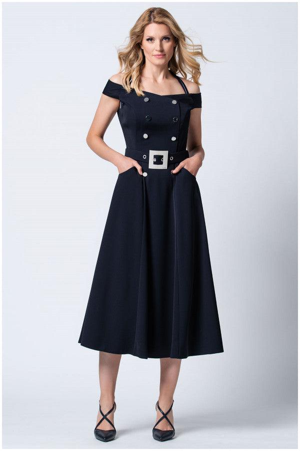 Woman wearing navy off-shoulder elegant midi dress with buttons and pockets against a white background