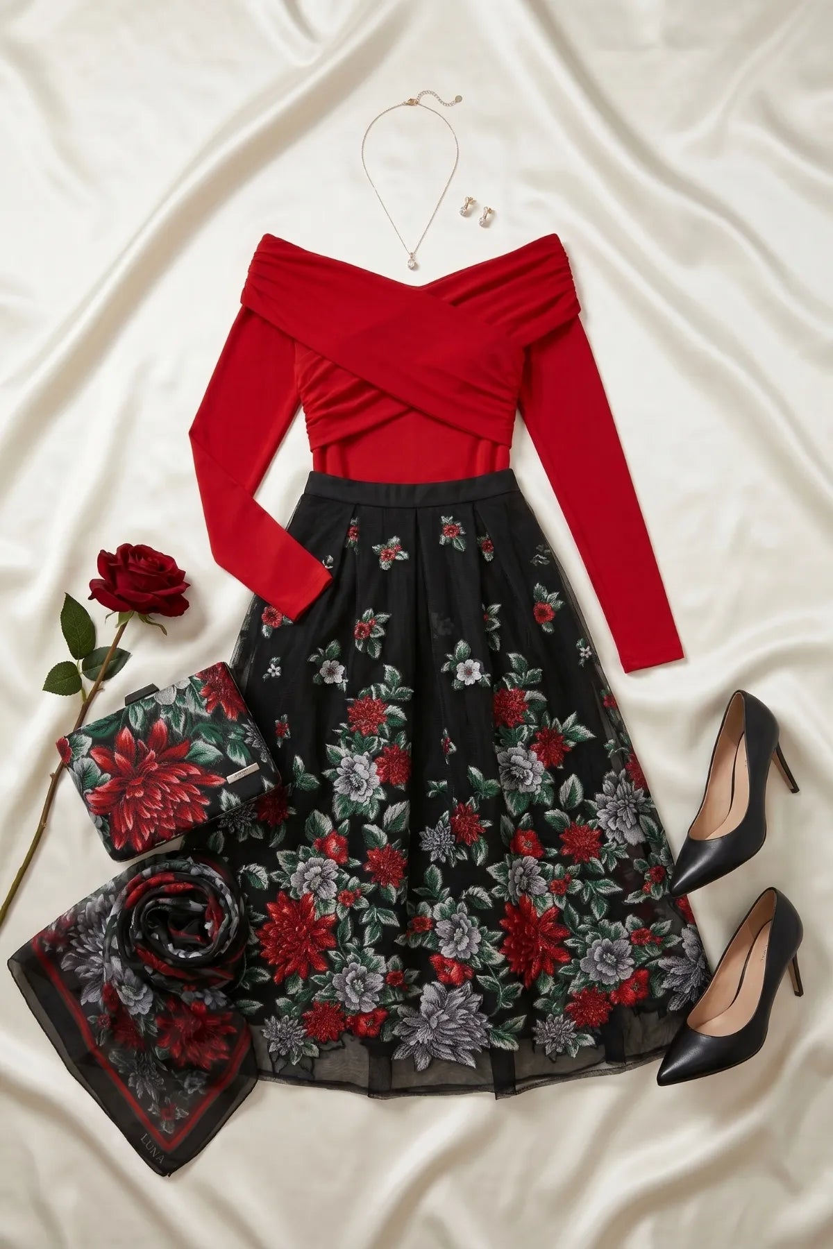 Regina floral clutch styled with a red off-shoulder top, black floral skirt, scarf, and black pumps.