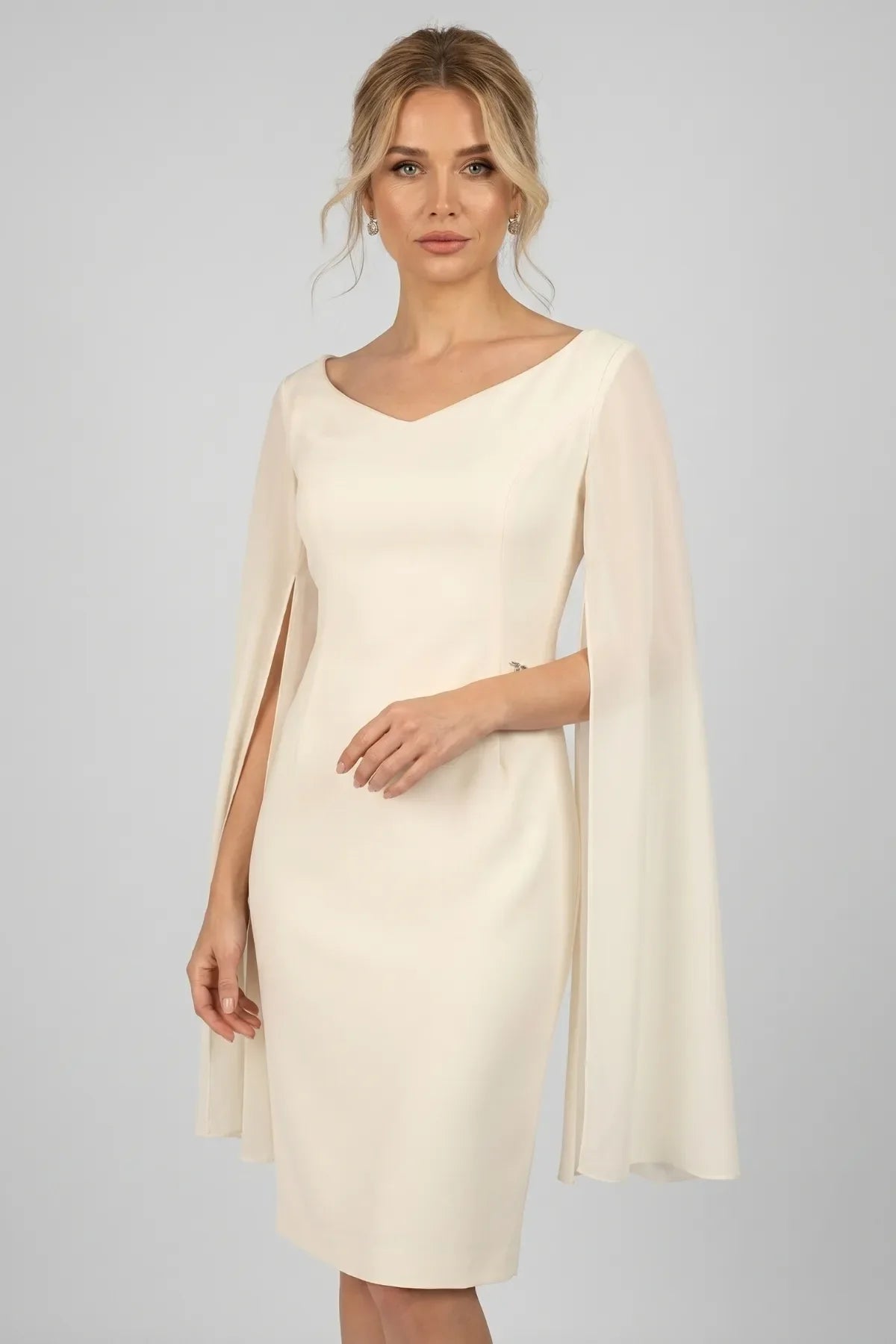 Back of Rebeka ivory dress with concealed zipper, V back, hem vent and sheer cape sleeves