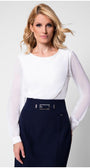 Model in white viscose blouse with sheer sleeves tucked into tweed skirt