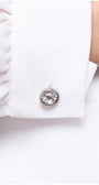 Close up of crystal cuff button on white viscose blouse
