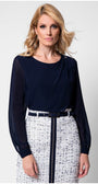 Model in navy viscose blouse with sheer sleeves and tweed skirt front view