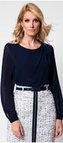 Model in navy viscose blouse with sheer sleeves and tweed skirt front view