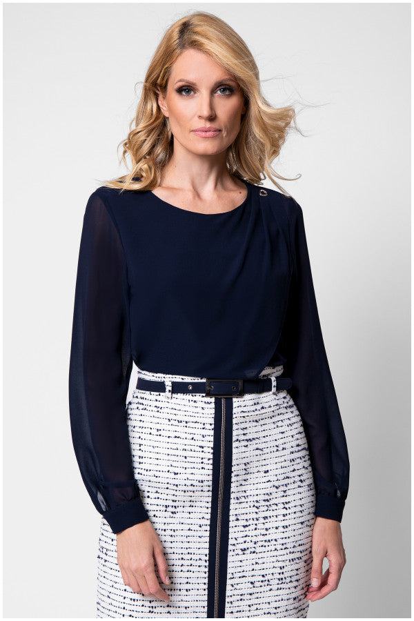 Model in navy viscose blouse with sheer sleeves and tweed skirt front view
