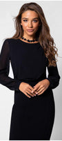 Front view of model in black viscose blouse with sheer sleeves