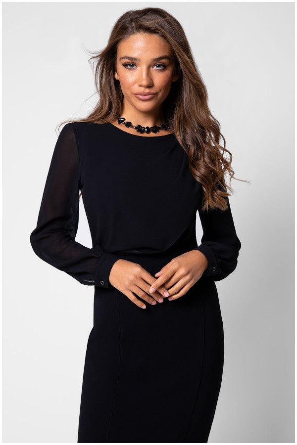 Front view of model in black viscose blouse with sheer sleeves