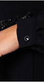 Close up of crystal cuff button on black viscose blouse