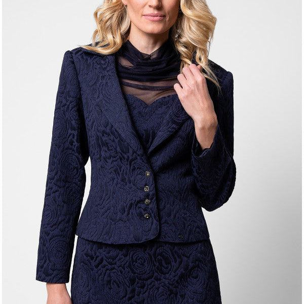 Model front three quarter in navy floral jacquard Peni blazer with matching pencil skirt