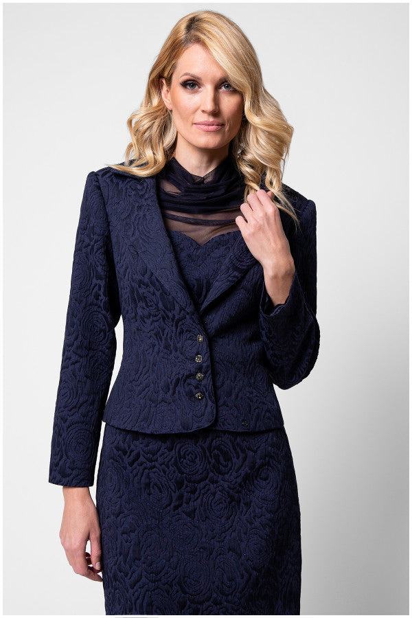 Model front three quarter in navy floral jacquard Peni blazer with matching pencil skirt
