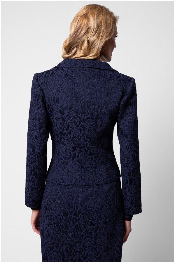 Back view of model in Peni navy floral jacquard blazer highlighting sculpted seams