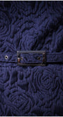 Close up of belt and rose weave on navy floral jacquard dress