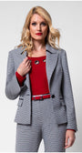 Woman wearing tailored blazer Elena with houndstooth pattern, black collar accents, and matching trousers in a business outfit