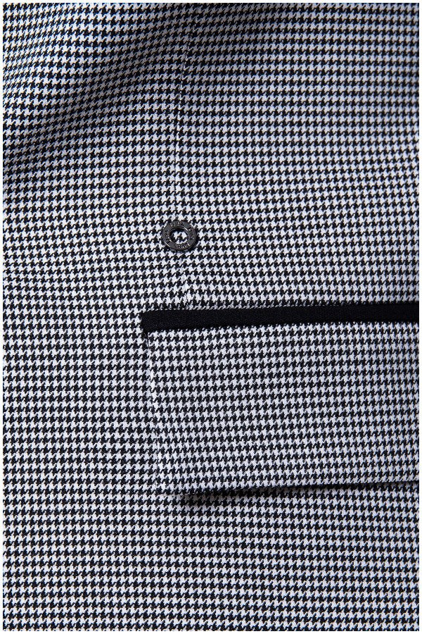 Close-up of Elena tailored blazer houndstooth pattern with black pocket trim and single button closure detailing