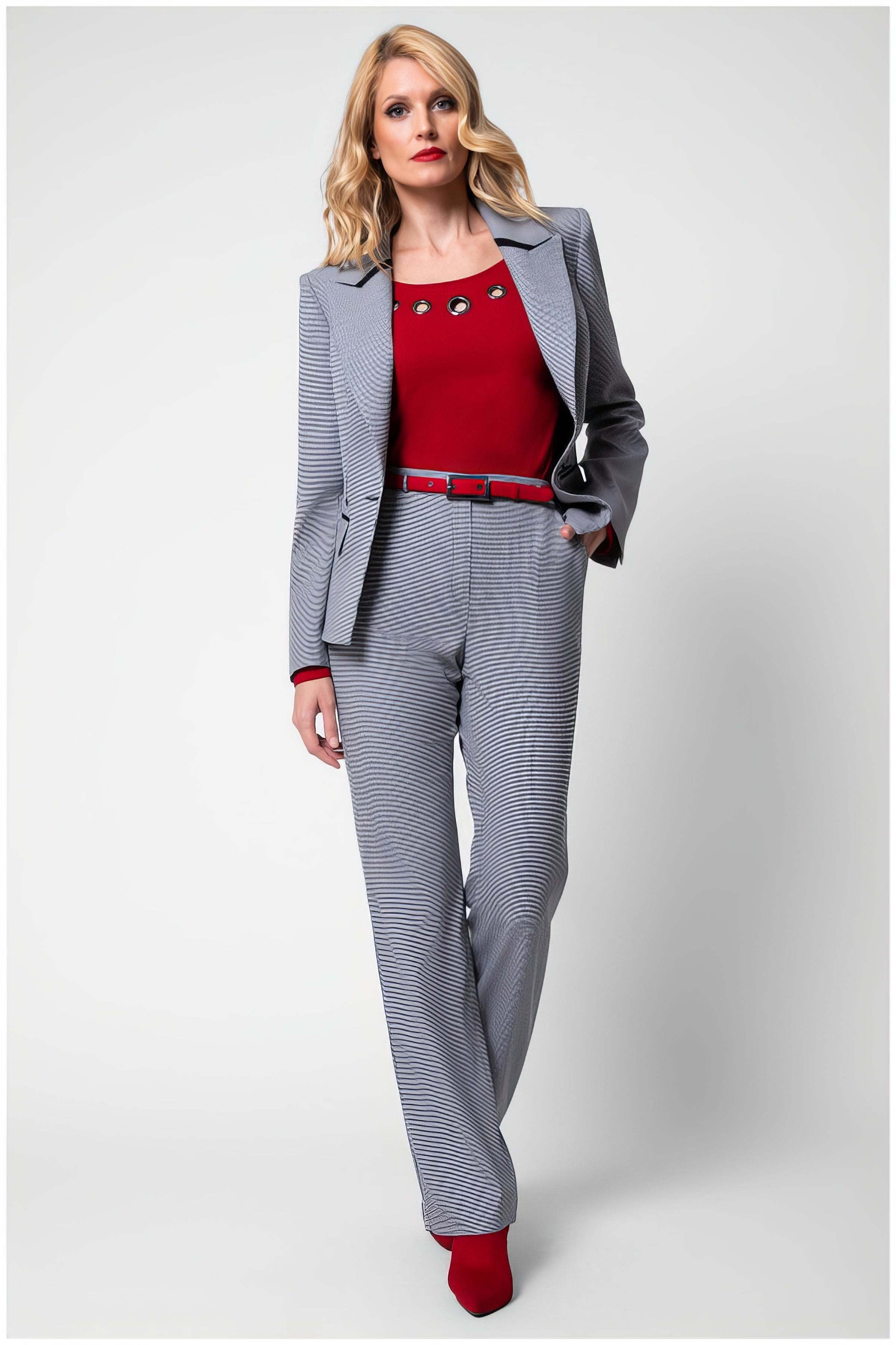 Woman wearing Elena Houndstooth Tailored Trousers with matching blazer and red top for a chic modern look