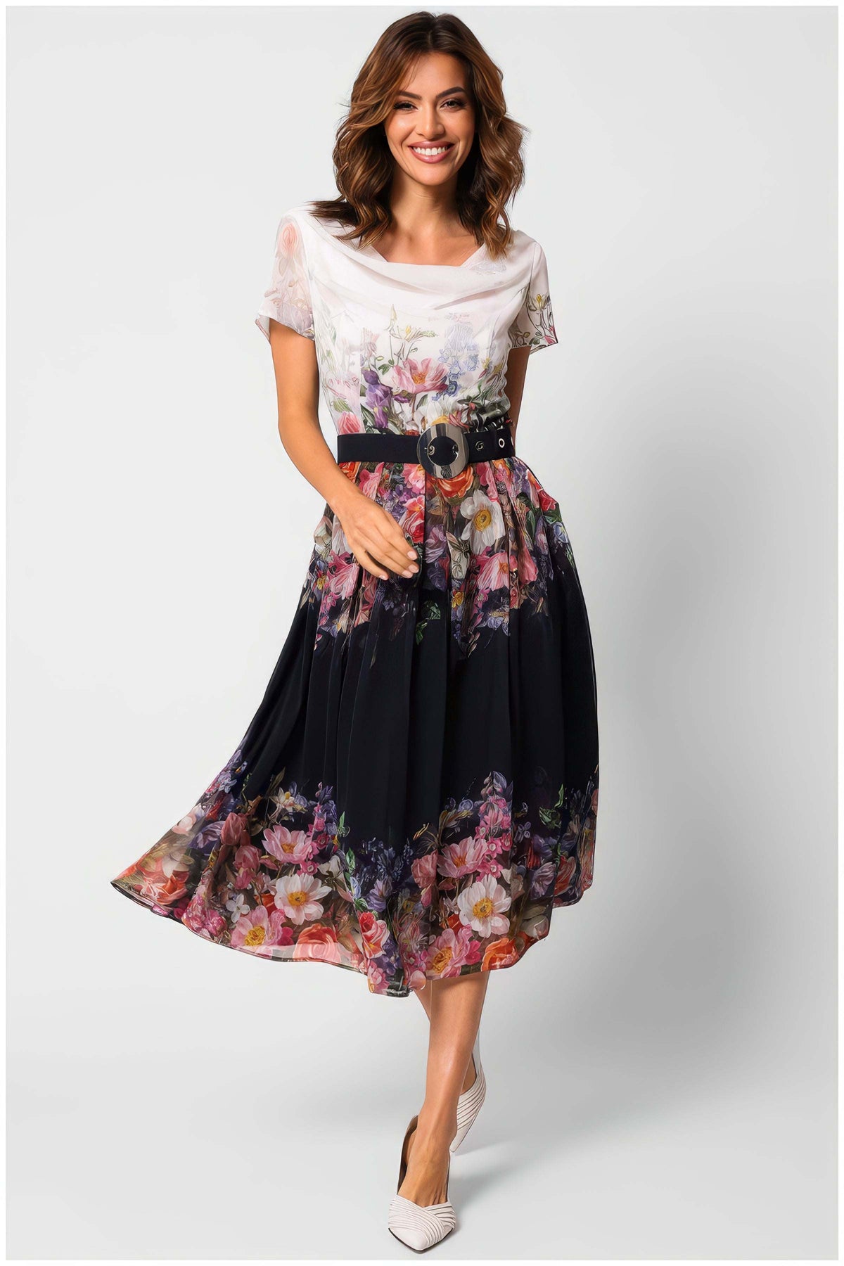 Navy Floral Elegant Midi Dress, Julia. Floral midi dress. White draped bodice shading to a navy flared skirt with a multicolor floral print and a wide belt, on model.