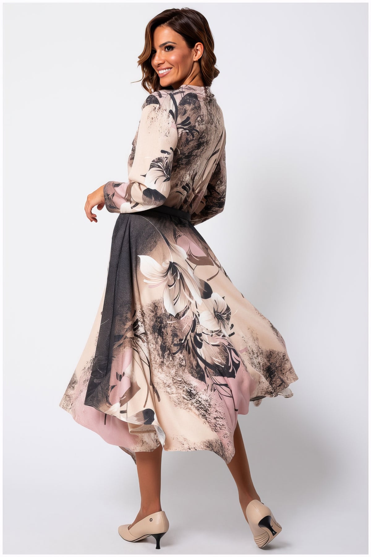 Woman twirling in Iris A-line Midi Dress in Blush Floral with soft floral patterns and flowing natural viscose fabric