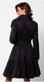 Back view of woman wearing Iris Short Tailored Coat in Deep Black with pleated skirt and belt detail