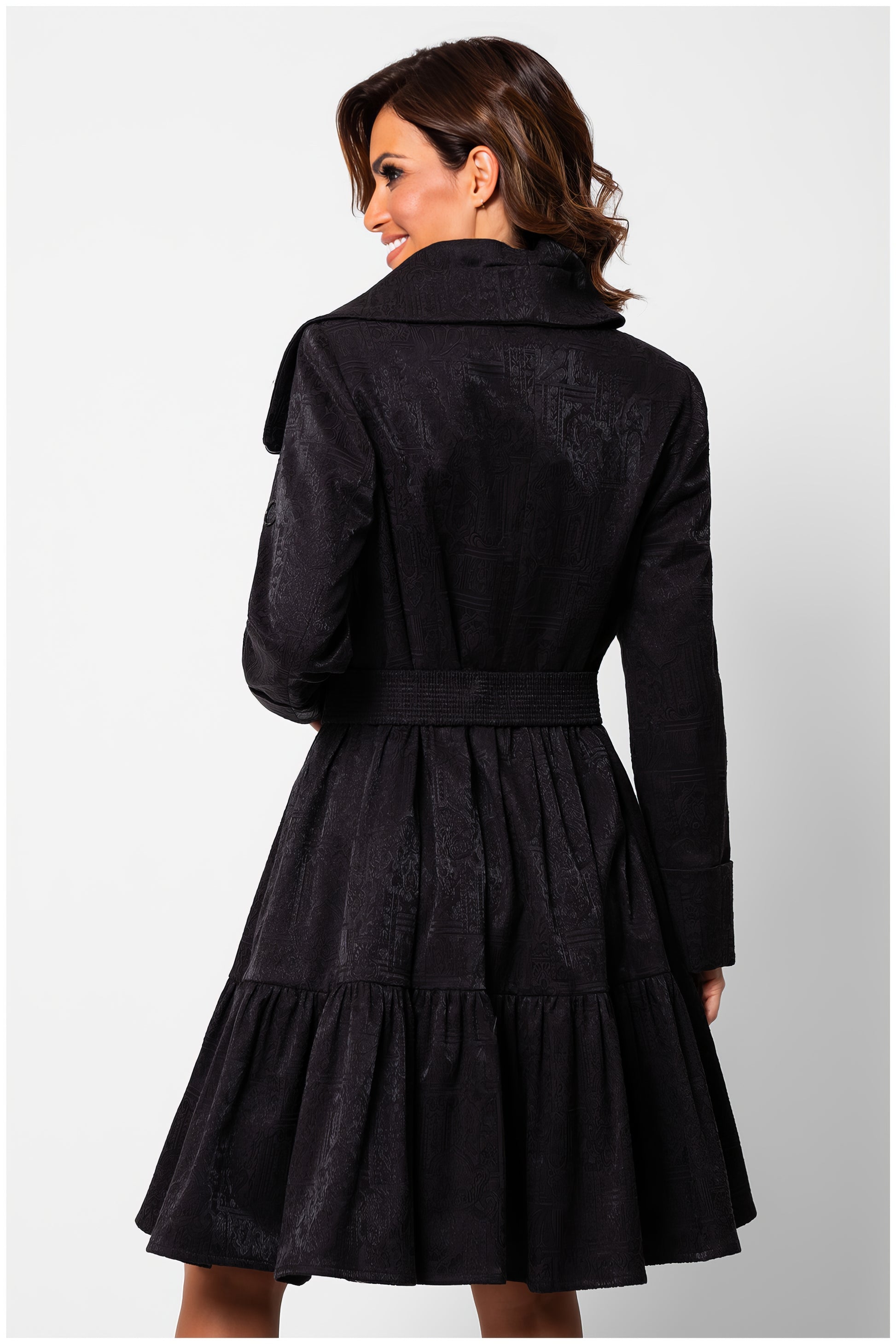 Back view of woman wearing Iris Short Tailored Coat in Deep Black with pleated skirt and belt detail