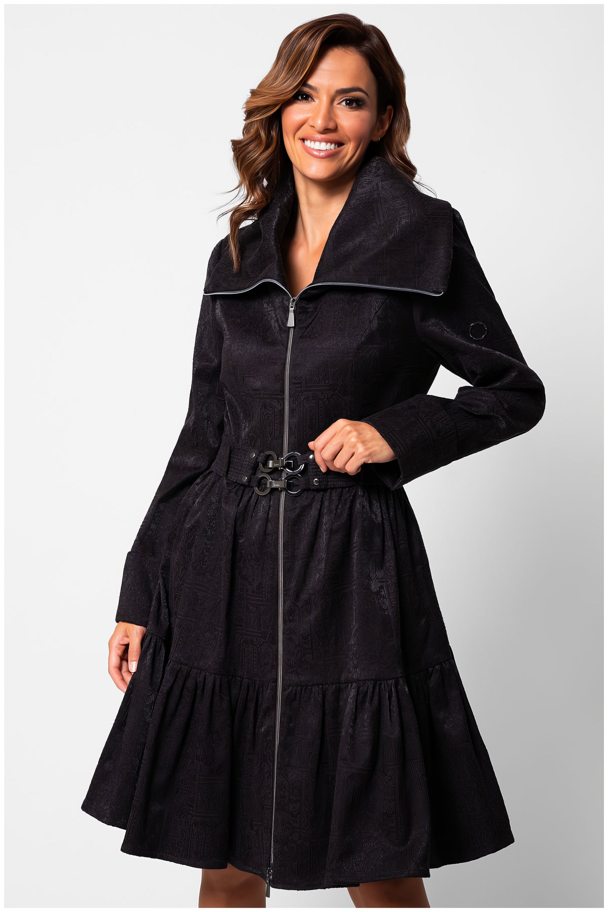 Woman wearing Iris Short Tailored Coat in Deep Black with wide collar and belted waist, smiling against white background