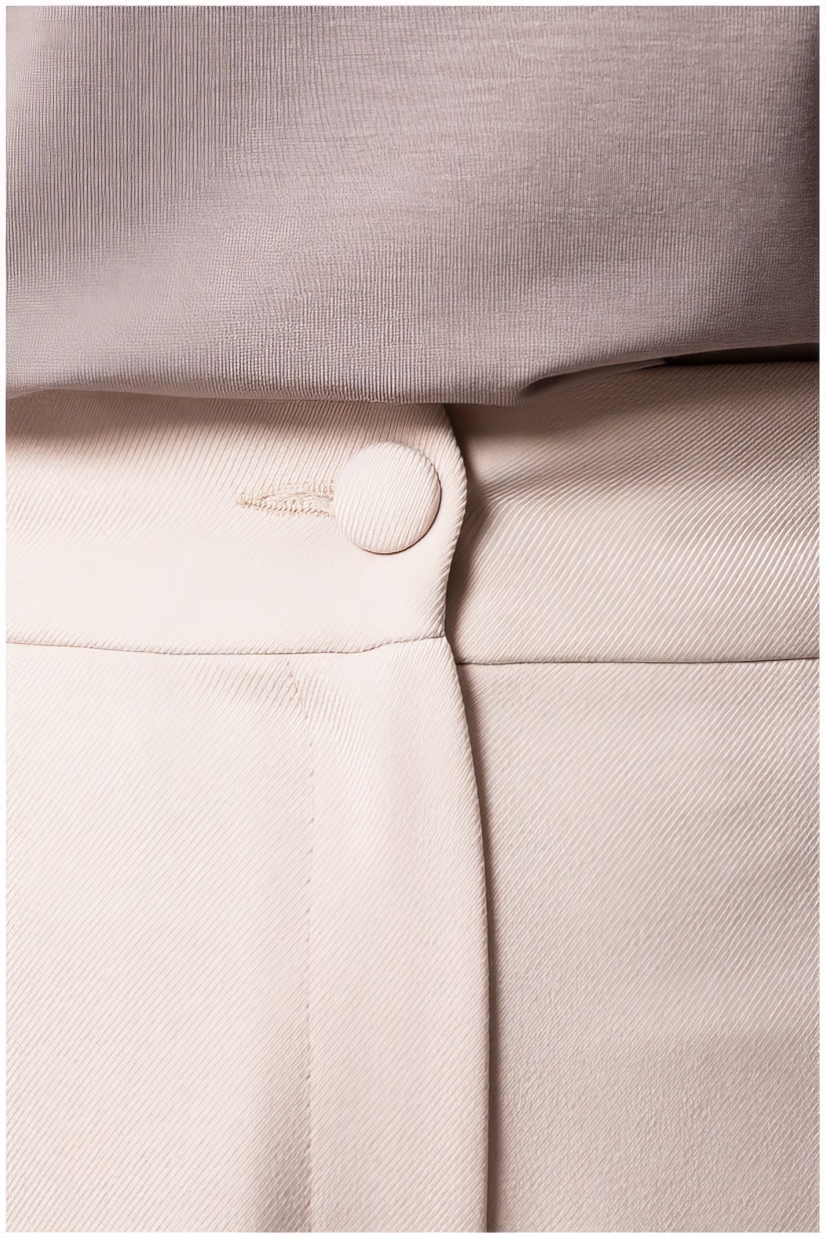 Close-up detail of the button and waistband on the Natasha Wide Leg Trousers in Sand Beige showing smooth fabric texture