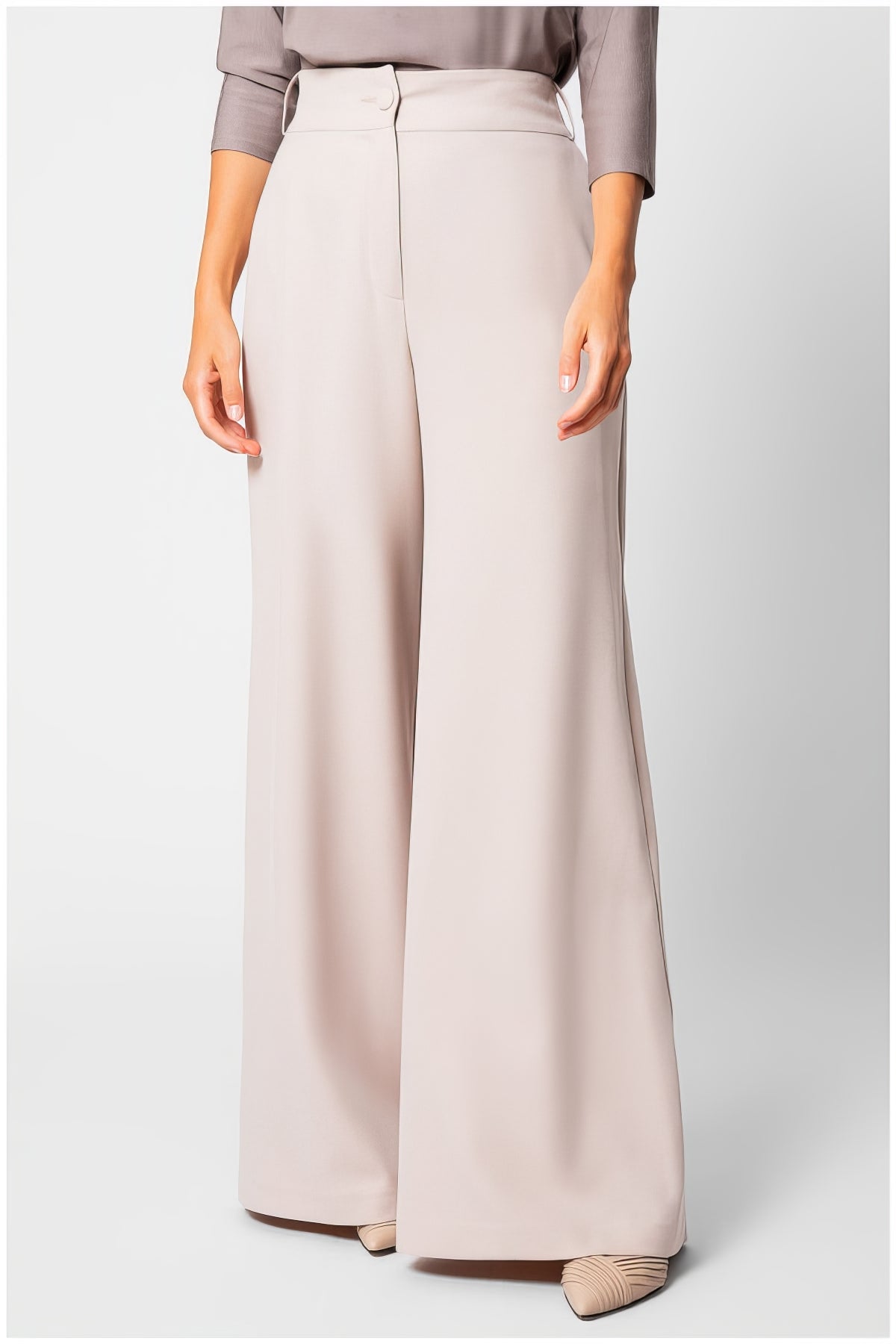 Natasha Wide Leg Trousers in Sand Beige with smooth texture and elegant flowing silhouette on a model