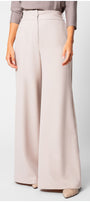 Natasha Wide Leg Trousers in Sand Beige with smooth texture and elegant flowing silhouette on a model