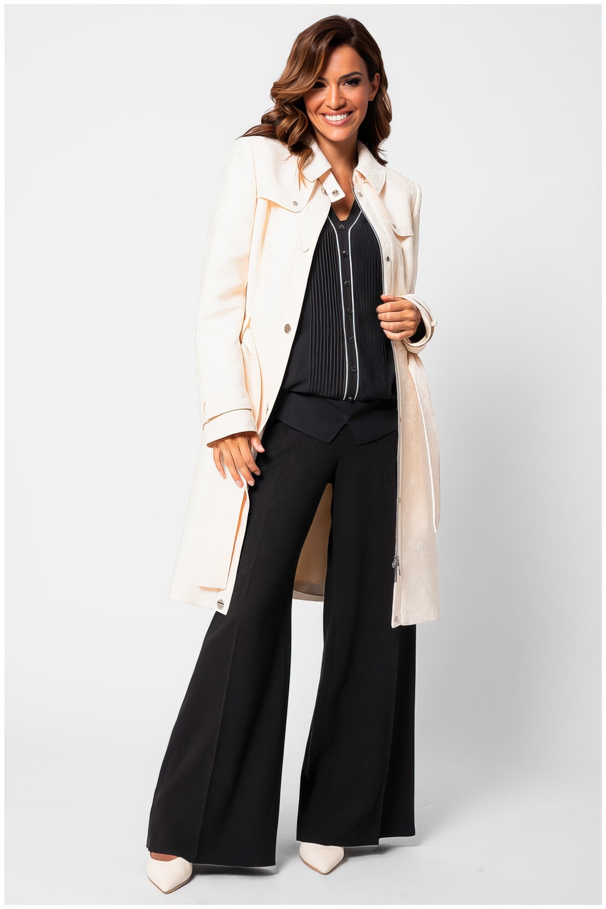Woman wearing Rea Jacquard Trench Coat in Beige styled with black wide-leg pants and a striped blouse