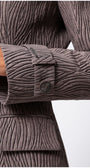 Close-up of sleeve and pocket detail on Isidora Long Textured Coat in Mocha showcasing textured fabric and button design