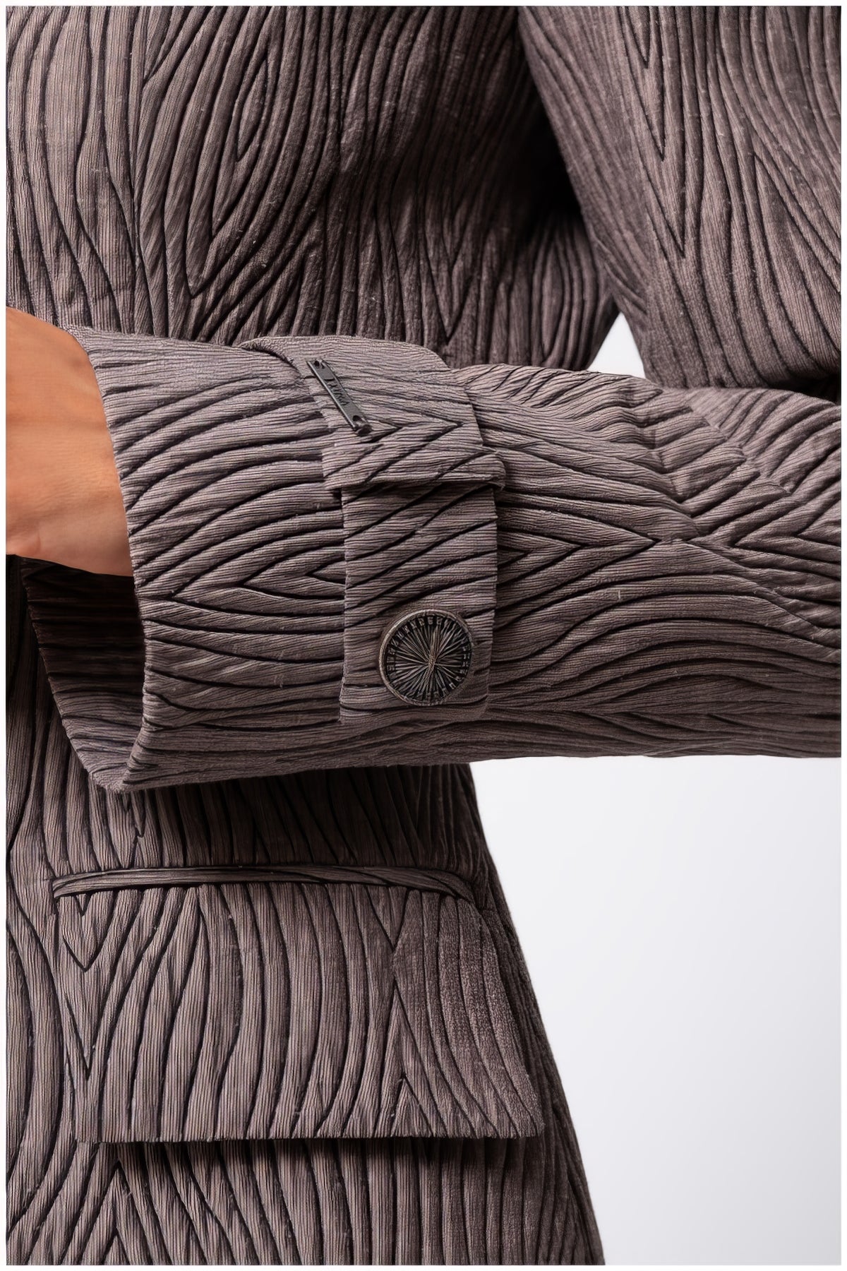 Close-up of sleeve and pocket detail on Isidora Long Textured Coat in Mocha showcasing textured fabric and button design