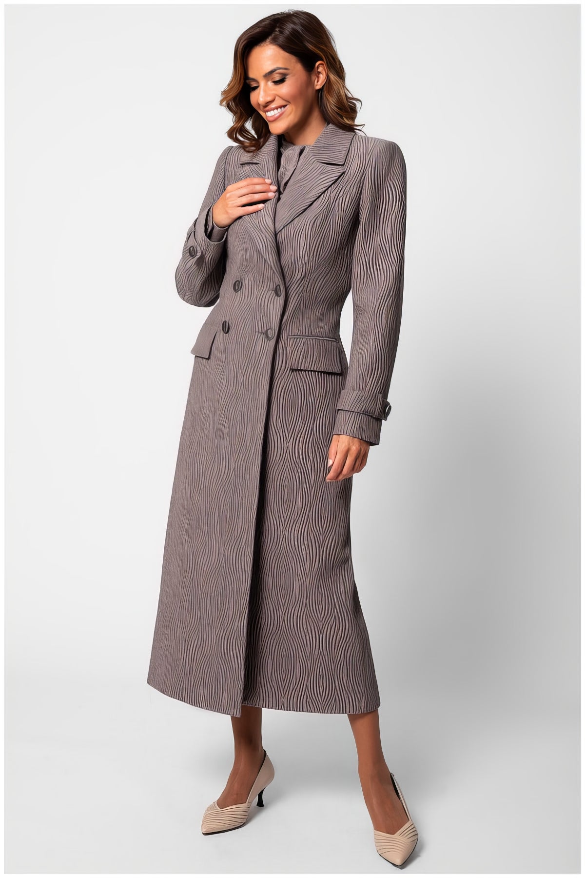 Woman wearing an elegant Isidora Long Textured Coat in Mocha with tailored fit and wave-like fabric pattern