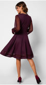 Woman wearing Jody Lace A-Line Dress in Bordeaux with sheer sleeves and flared skirt, styled with matching heels