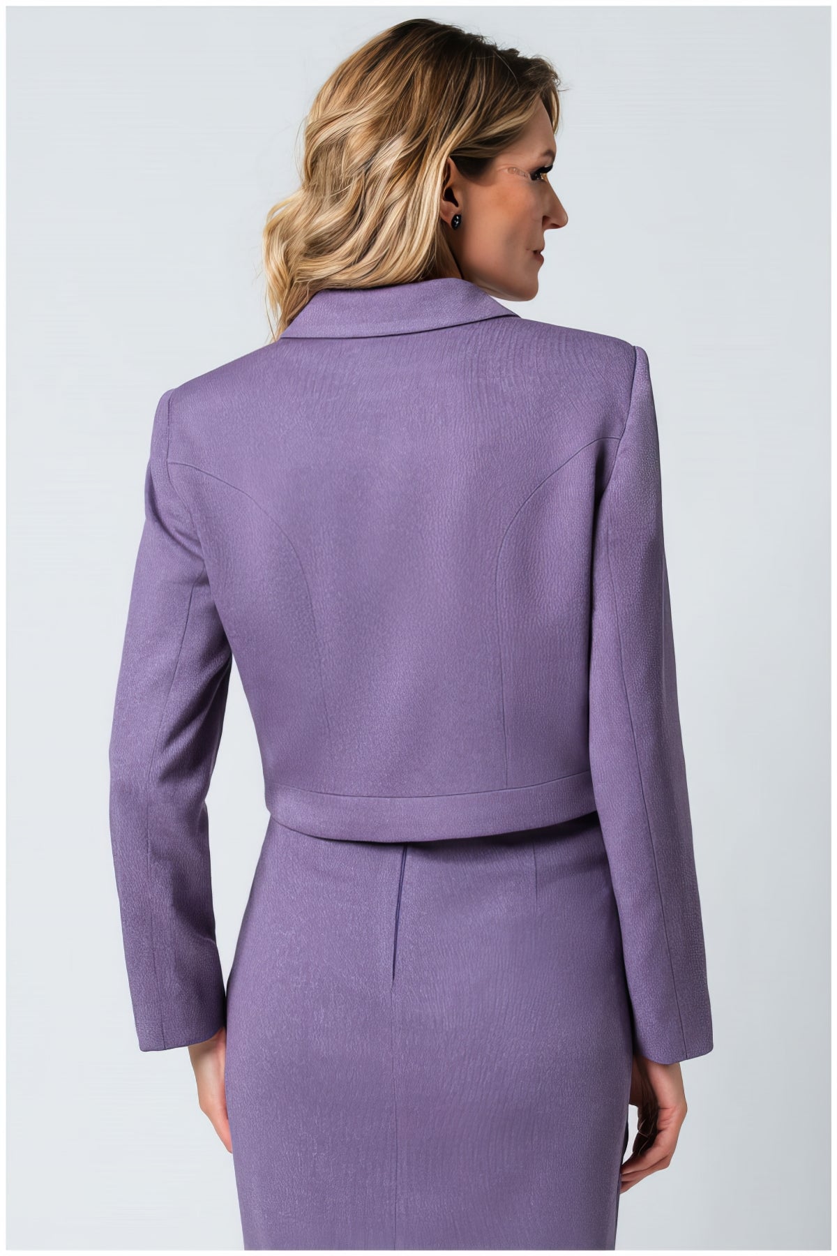 Back view of a woman wearing the Neda Cropped Zip Blazer in Lilac with tailored hip-length design.